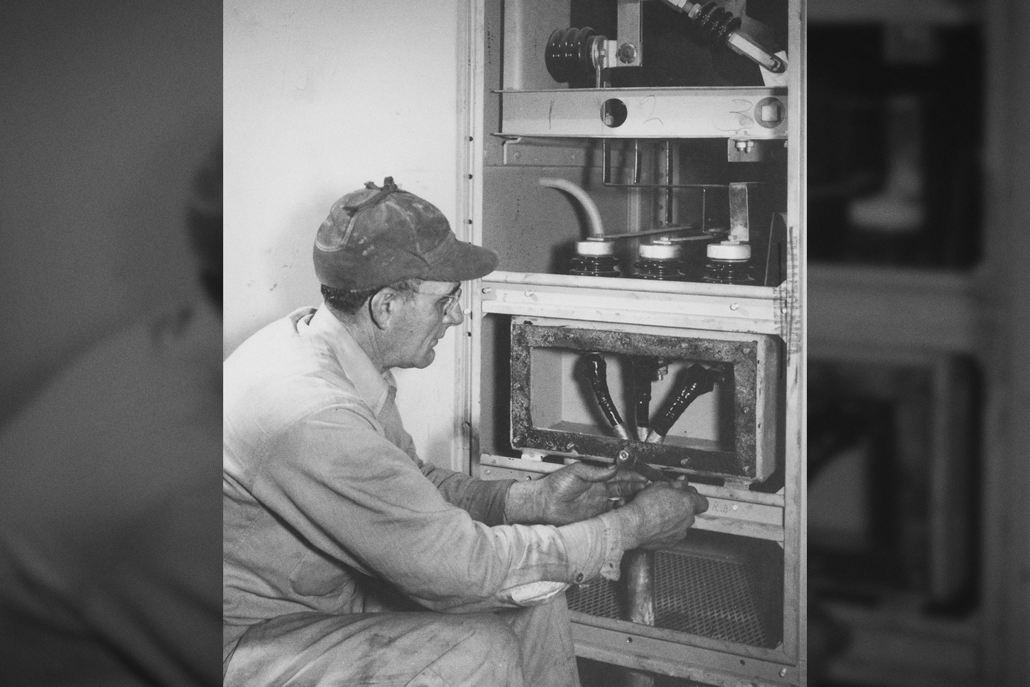 Electrician connecting underground feeder cable to transformer in K-25 Building Vault, February 6, 1945